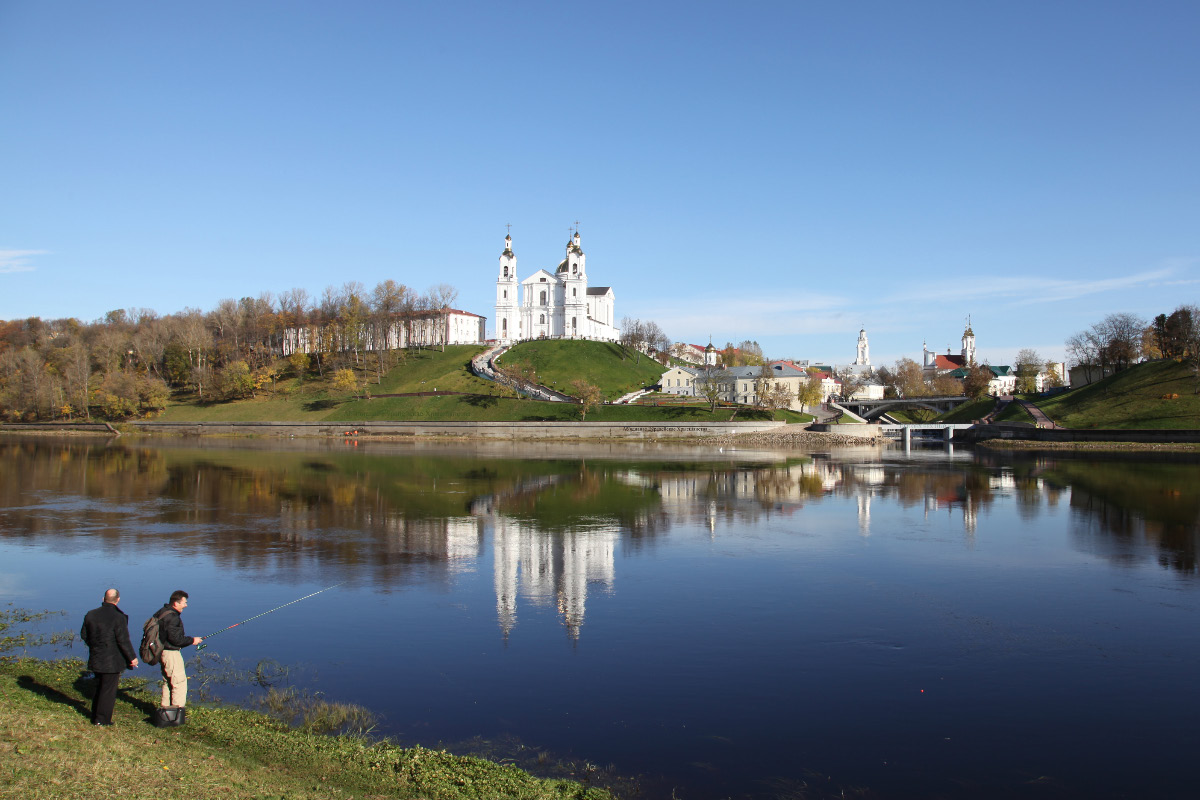 on 18 October 2012 view of Dormition Cathedral across the Western Dvina River and fishermen