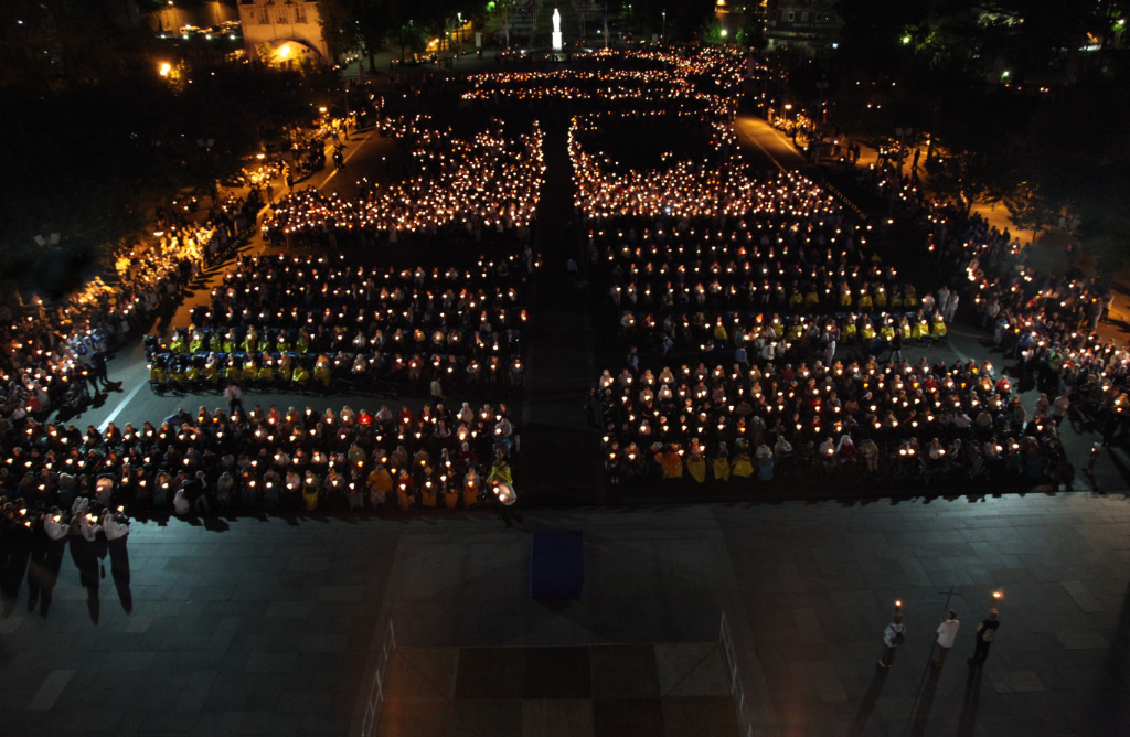 prayer by candlelight at Lourdes