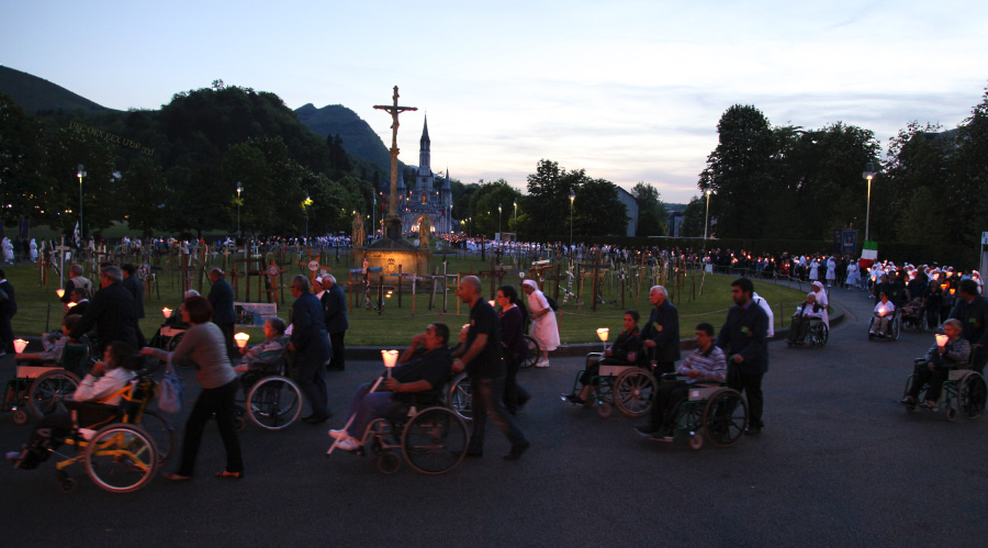 procession at dusk in Lourdes