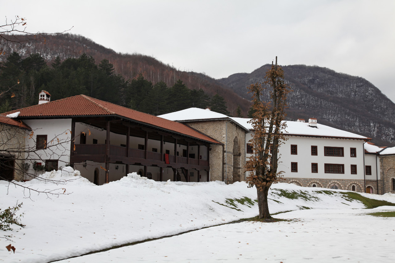 the Visoki Dečani Monastery lies in the, topographically speaking, gentle Dečanska Bistrica river gorge at the foot of these imposing mountains. Pictured here are monastic cells and the main entrance way into the monastery complex
