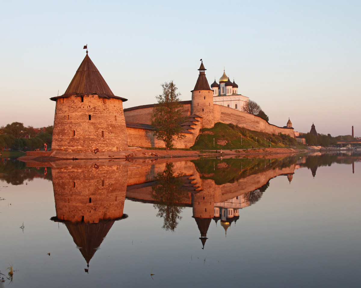 Pskov Kremlin at the point where the Pskov River flows into the Great River, the Flat Tower stands nearest and is reflected in the Pskov River